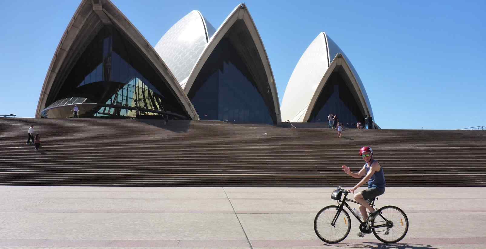 Man riding park past Opera house