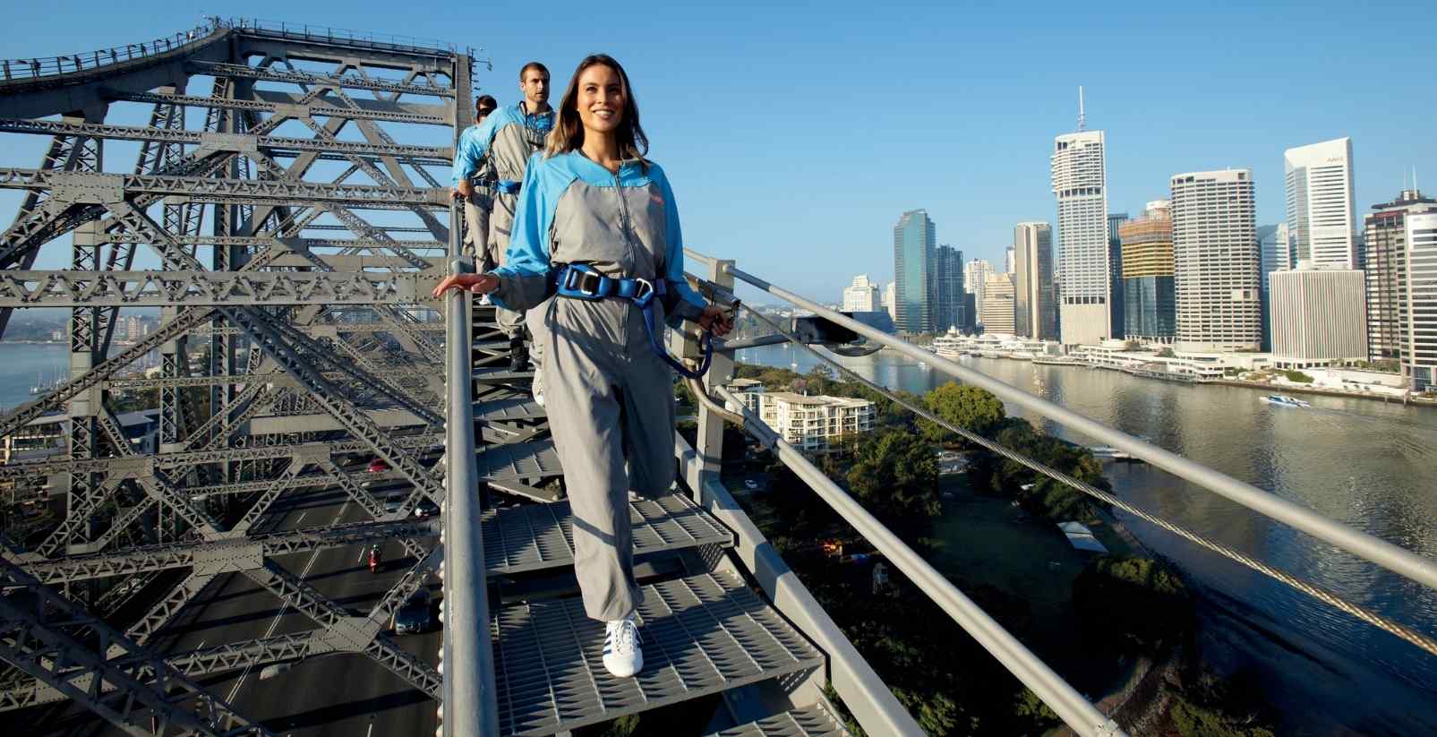 people walking over sydney bridge